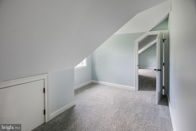 bonus room featuring light carpet and lofted ceiling