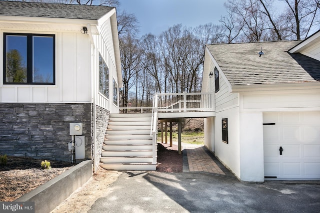 view of side of home featuring a wooden deck and a garage