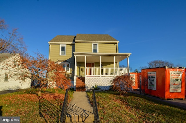 view of front of house with a front lawn and a porch