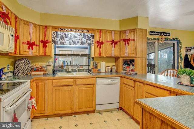 kitchen featuring white appliances and sink