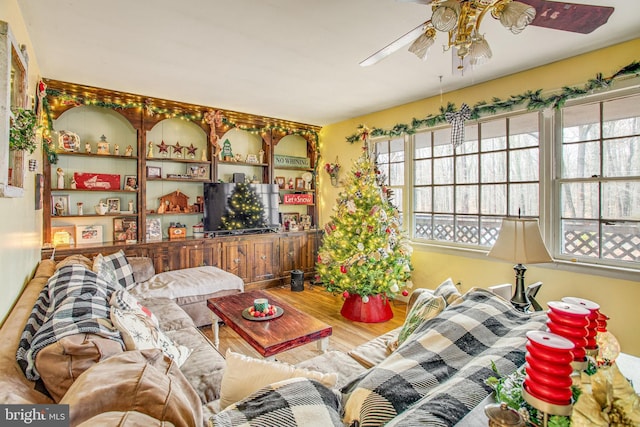 living room featuring hardwood / wood-style floors and ceiling fan