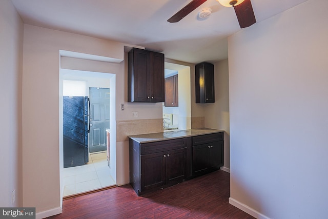 kitchen with ceiling fan, dark hardwood / wood-style flooring, and dark brown cabinets