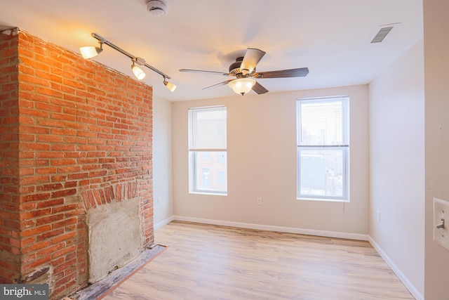 unfurnished living room featuring ceiling fan and light hardwood / wood-style flooring