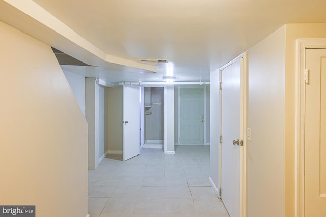 hall featuring light tile patterned floors