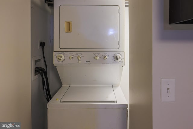 washroom featuring stacked washer and dryer