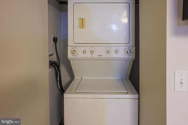 laundry room with stacked washing maching and dryer