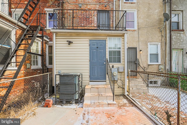 property entrance featuring central AC unit