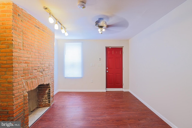 foyer entrance featuring a fireplace and hardwood / wood-style flooring