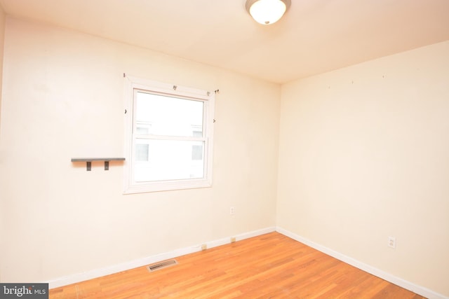 spare room with hardwood / wood-style flooring