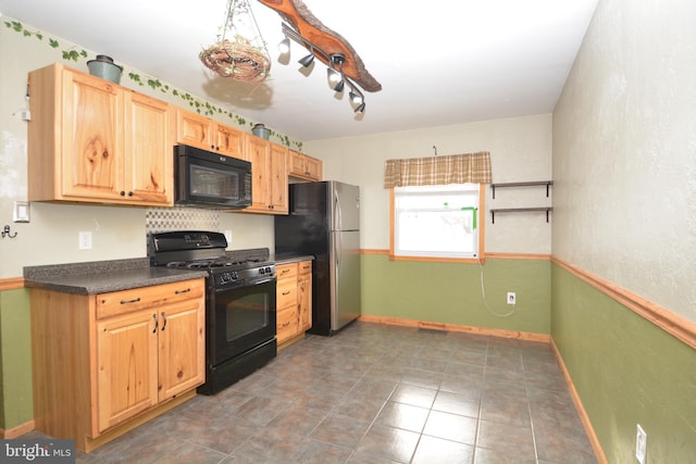 kitchen featuring light brown cabinetry, track lighting, and black appliances