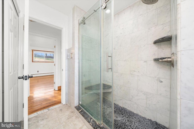 bathroom with a shower with shower door and a baseboard radiator