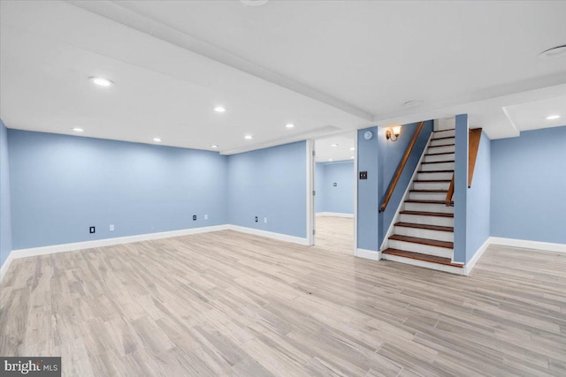 basement with light hardwood / wood-style floors