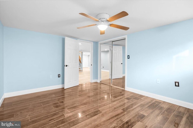 interior space with ceiling fan and dark wood-type flooring