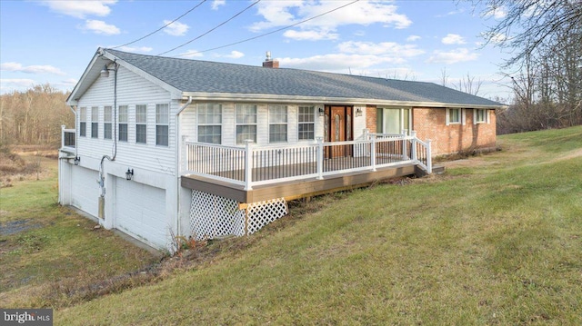 view of front of home featuring covered porch, a garage, and a front yard