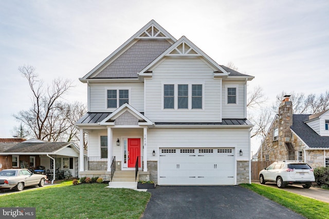 craftsman house with a front lawn, covered porch, and a garage