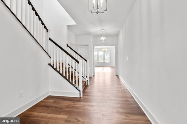 entrance foyer featuring dark hardwood / wood-style flooring and a notable chandelier