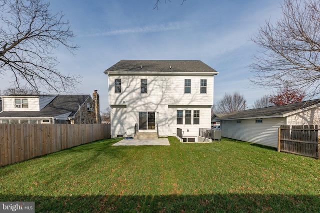 back of property with a lawn, central air condition unit, and a patio