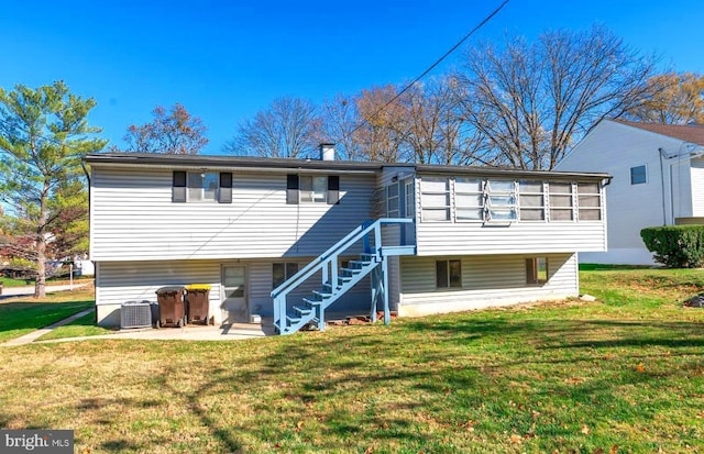 back of property with a yard, central AC, a patio area, and a sunroom