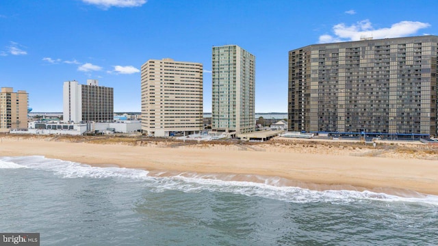 exterior space featuring a water view and a view of the beach