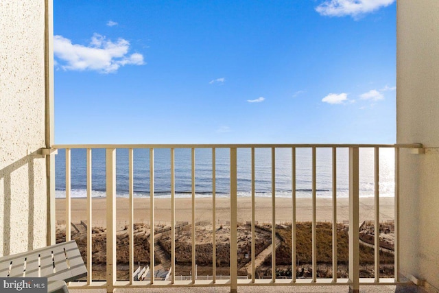 balcony with a view of the beach and a water view