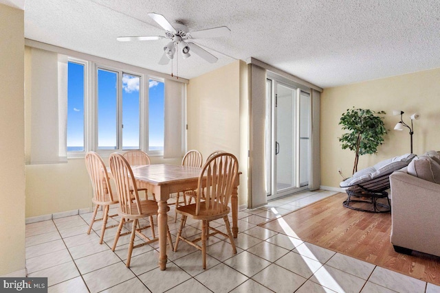 tiled dining room featuring ceiling fan and a textured ceiling