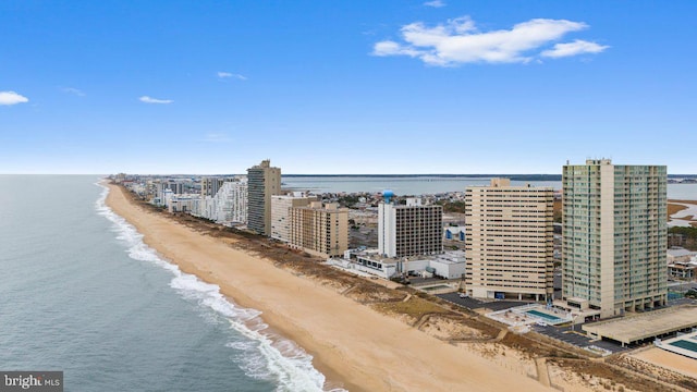 birds eye view of property with a beach view and a water view