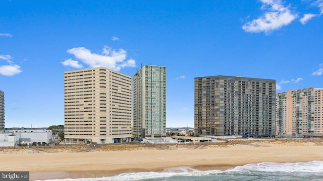 view of property featuring a view of the beach and a water view