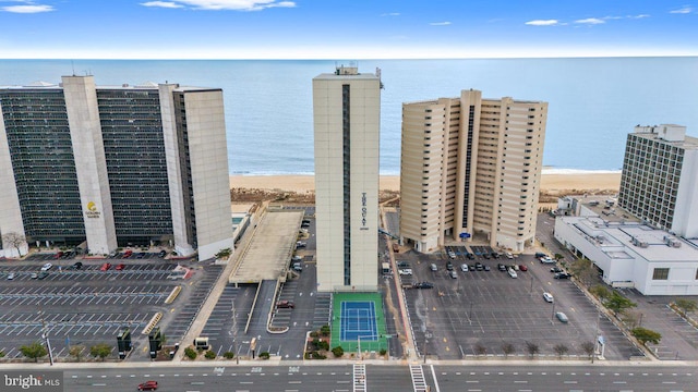 bird's eye view with a water view and a beach view