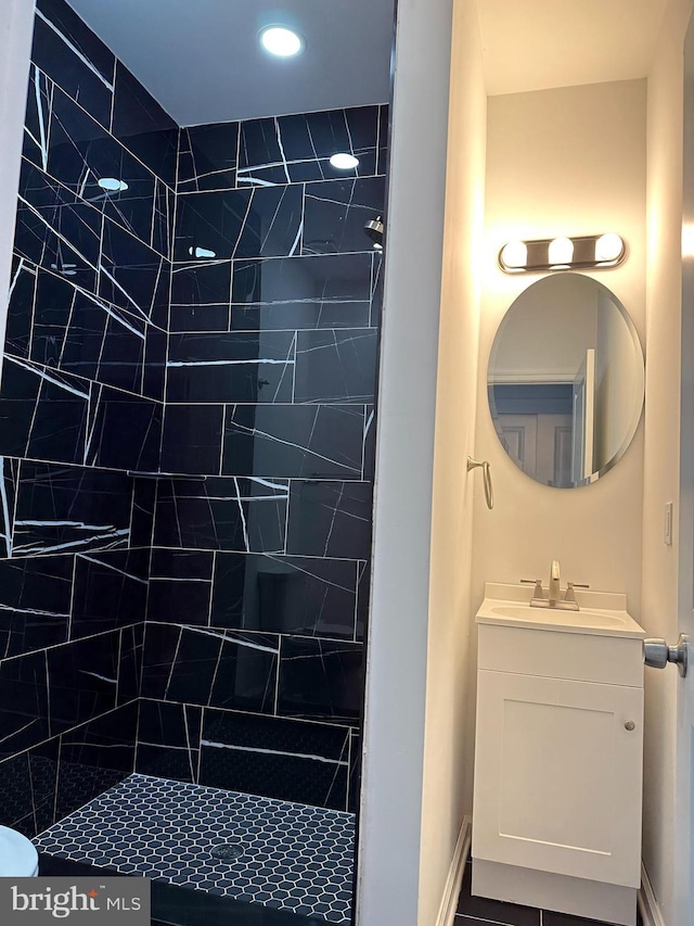 bathroom with vanity and tiled shower