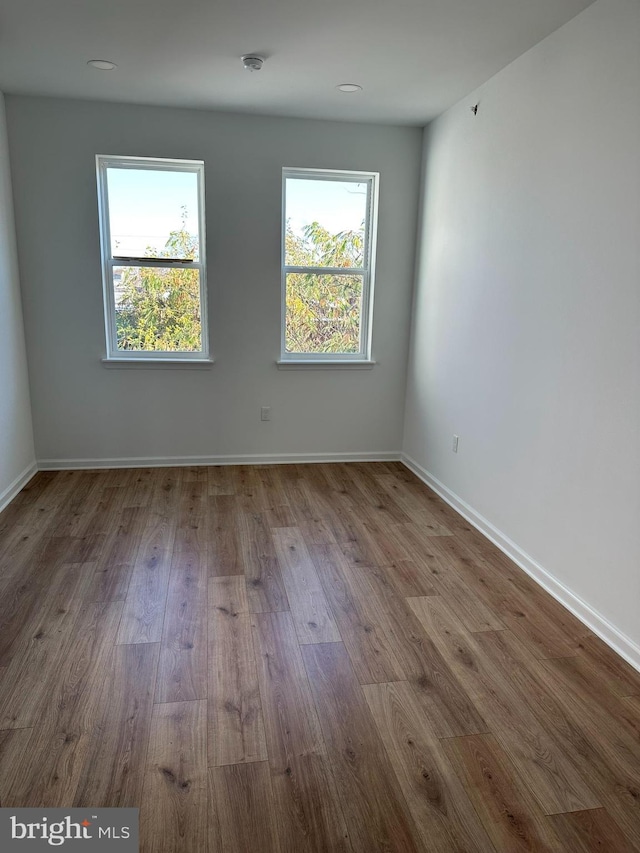2215 N 10th St, Philadelphia, PA 19133 - empty room with healthy amount of natural light and wood finished floors