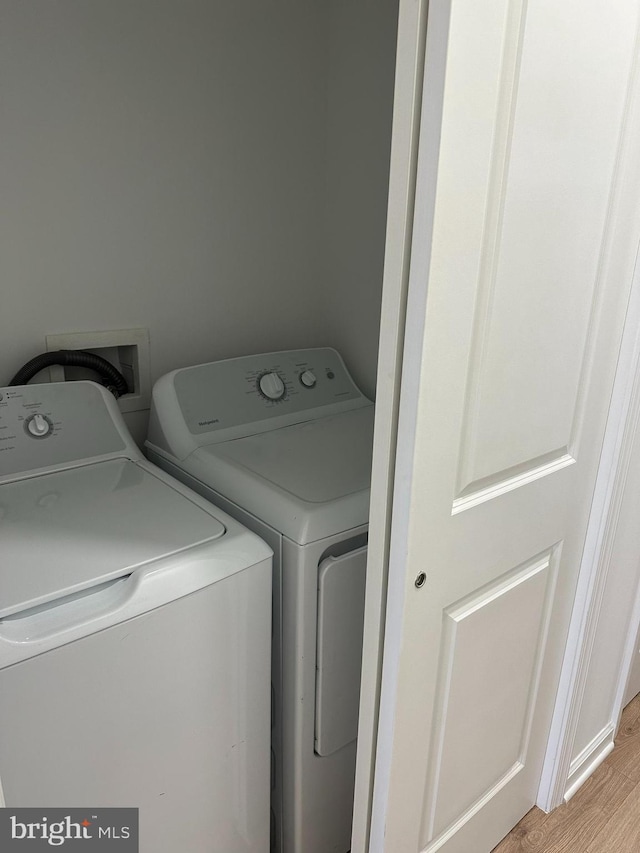 2215 N 10th St, Philadelphia, PA 19133 - laundry area featuring washing machine and dryer and light wood-style floors
