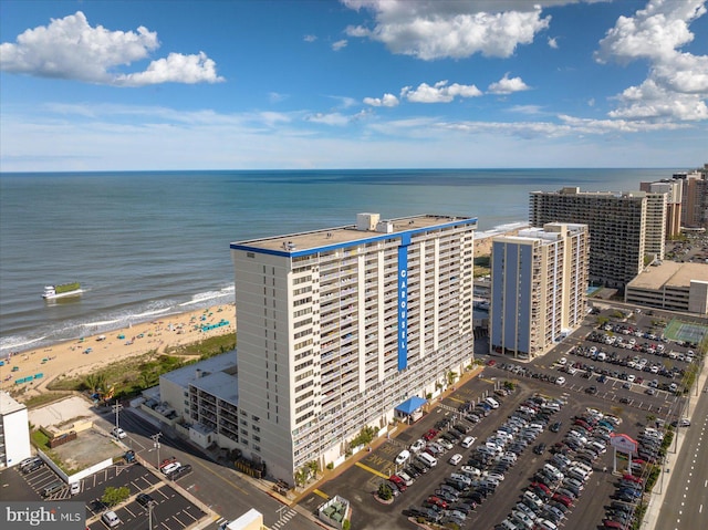 birds eye view of property featuring a water view and a beach view