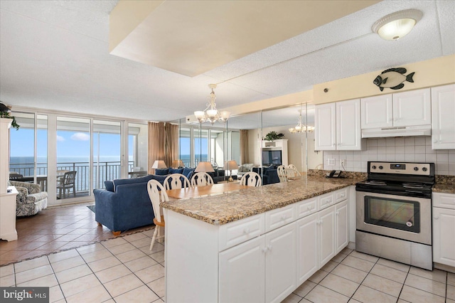 kitchen with tasteful backsplash, kitchen peninsula, stainless steel electric range, a water view, and white cabinets