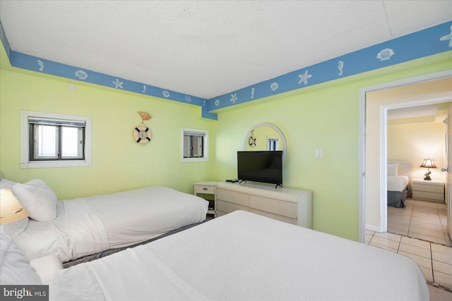 tiled bedroom with a textured ceiling