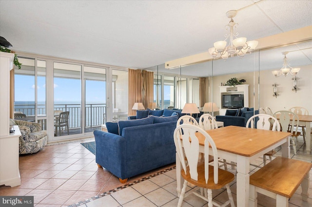 tiled dining area with floor to ceiling windows, a chandelier, a water view, and a healthy amount of sunlight