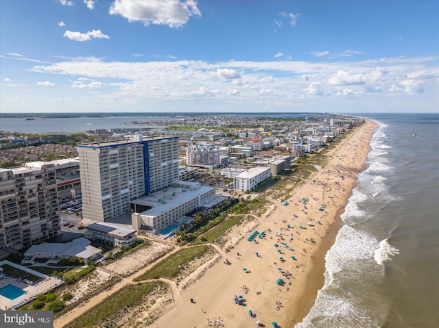 drone / aerial view with a beach view and a water view