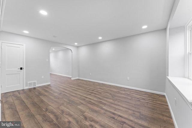 unfurnished room with dark wood-type flooring