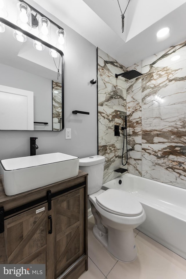 full bathroom featuring tile patterned floors, toilet, vanity, and tiled shower / bath