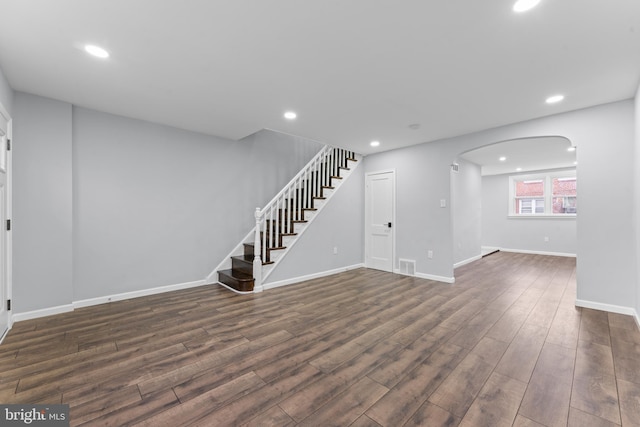 unfurnished living room featuring dark hardwood / wood-style floors