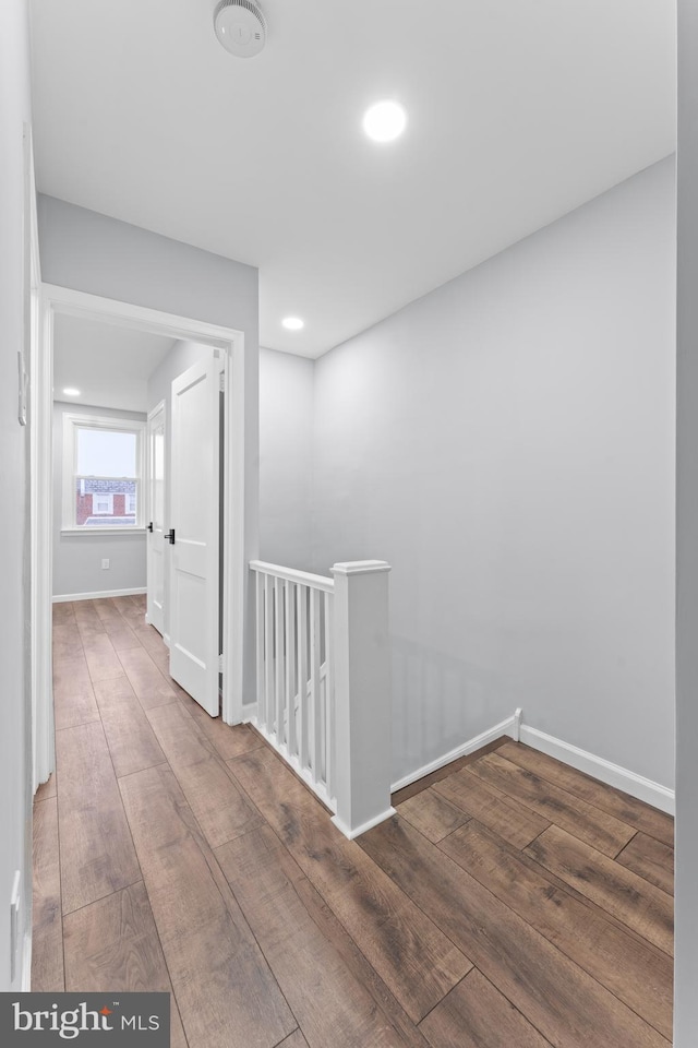 hallway with hardwood / wood-style flooring