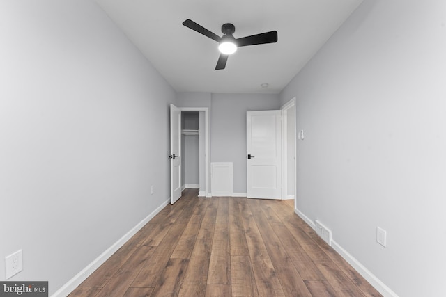 unfurnished bedroom featuring dark hardwood / wood-style floors and ceiling fan