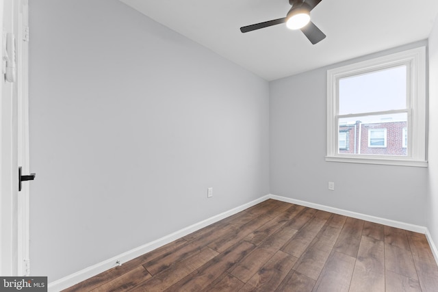 unfurnished room with ceiling fan and dark hardwood / wood-style flooring