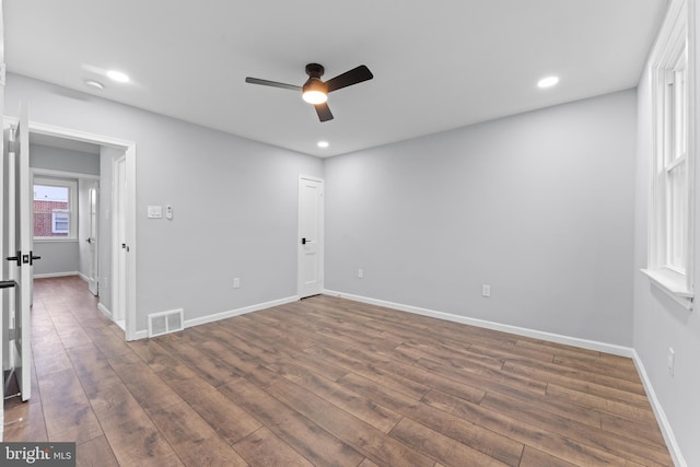 spare room featuring ceiling fan and dark hardwood / wood-style flooring