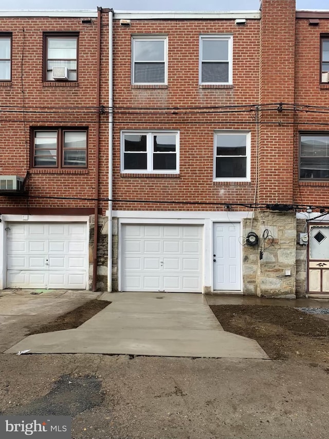 multi unit property featuring a garage