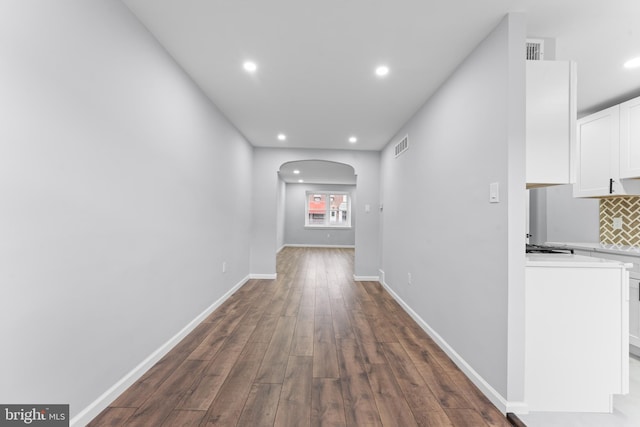 corridor featuring dark wood-type flooring