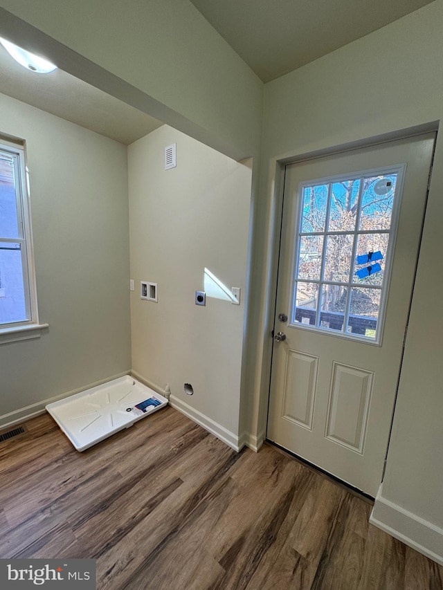 clothes washing area with hookup for an electric dryer, hardwood / wood-style floors, and hookup for a washing machine