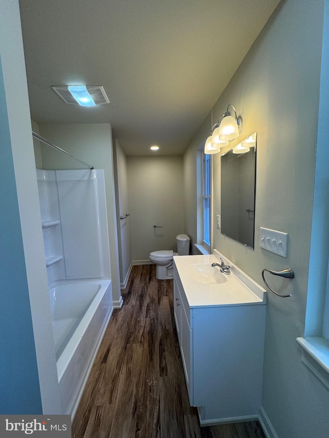 full bathroom with shower / washtub combination, toilet, vanity, and hardwood / wood-style flooring