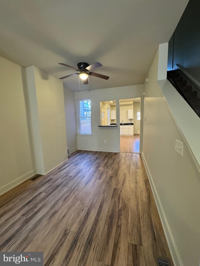 unfurnished living room with ceiling fan and hardwood / wood-style floors