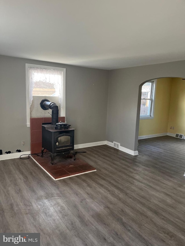 office featuring a wood stove and dark wood-type flooring