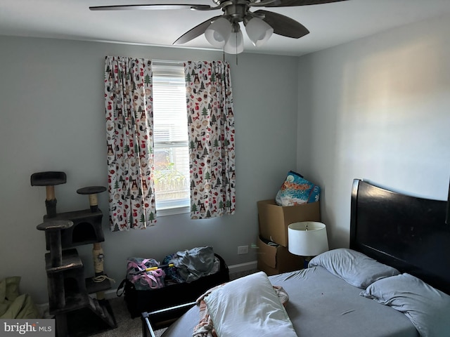 carpeted bedroom featuring ceiling fan and multiple windows